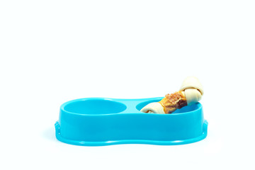 Pet supplies about bowl of blue color with bone for dog isolated on white.