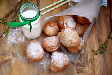 French doughnuts Beignet covered with sugar powder on a wooden table