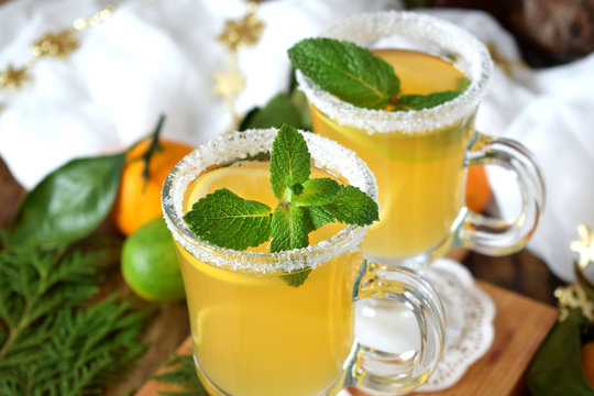 Yellow cocktail in Irish mugs decorated with sugar border and mint
