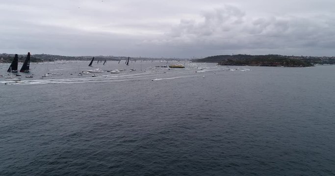 Super Maxi racing yachts clearing from South Head at the exit from Sydney harbour during annual Sydney Hobart Yacht race.

