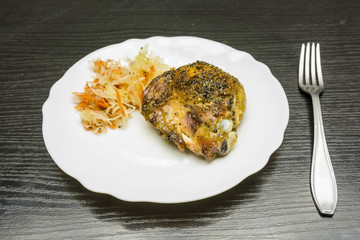 Roasted chicken leg with vegetable salad.
