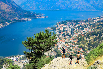 Montenegro tourists admire the view of the Bay, houses with red roofs