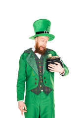 excited leprechaun looking at pot of gold, isolated on white