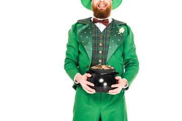 cropped view of leprechaun in green suit holding pot of gold, isolated on white
