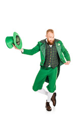 handsome leprechaun in green costume holding hat, isolated on white
