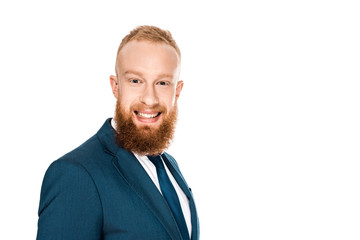 portrait of handsome bearded young businessman smiling at camera isolated on white