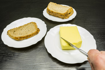 Breakfast. Butter cut with a knife to be applied to bread.
