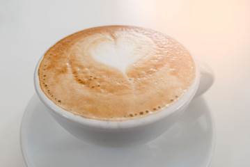 Closeup Hot coffee cup on the white  table .