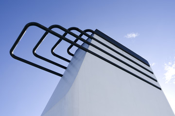 Seafaring: White funnel of a RoRo vessel in front of the bright blue sky