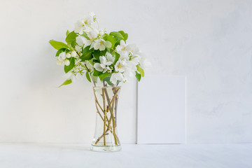 Mockup with a white frame and white spring flowers