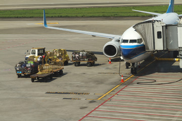 Aircraft Ground Handling, Loading cargo on plane in airport before flight.