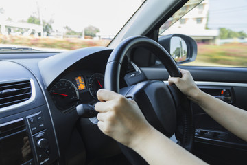 Driving car hands on steering wheel.