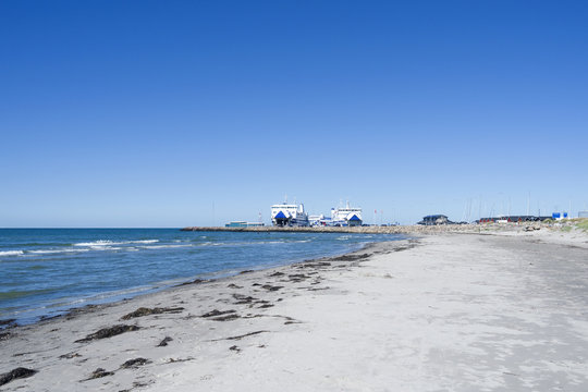 Laesoe / Denmark: View over the beautiful sand beach to the ferry terminal in Vesteroe Havn