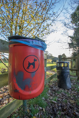 Red dog waste bin. Responsible pet ownership.