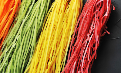 Colorful pasta on a black background
