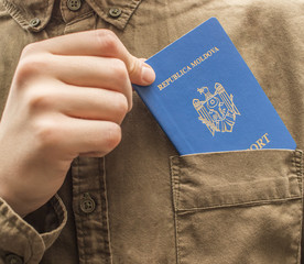 A man takes out his passport from shirt pocket close up. Tourism and travel concept. Selective focus and shallow DOF.
