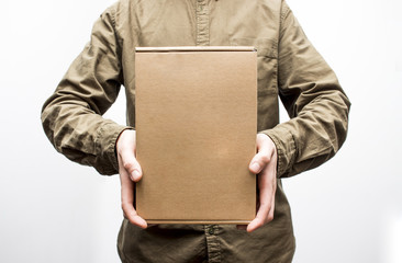 Delivery, mail and people concept - close up of man with cardboard box or parcel isolated on white background. Selective focus and shallow DOF.