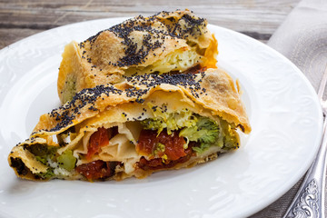 Strudel with cheese and sun-dried tomatoes. Homemade pie, strudel and snacks