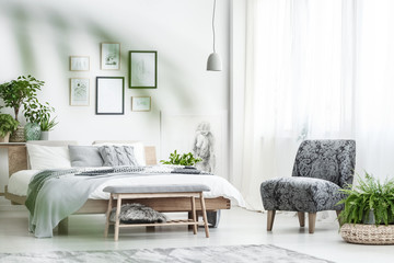 Armchair and fern in bedroom