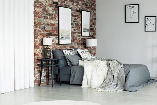 Grey apartment with brick wall