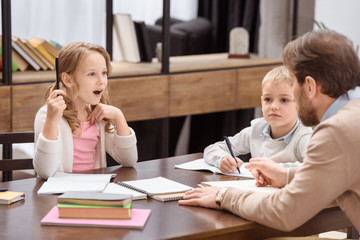 surprised daughter showing father idea gesture