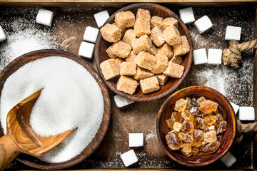 Different kinds of sugar in bowls on a tray.