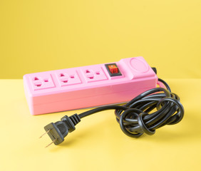Power plug socket on yellow background