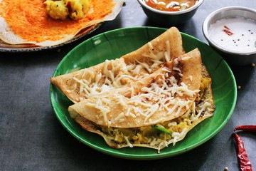 Cheese Dosa / Indian breakfast crepes with cheese potato filling, selective focus