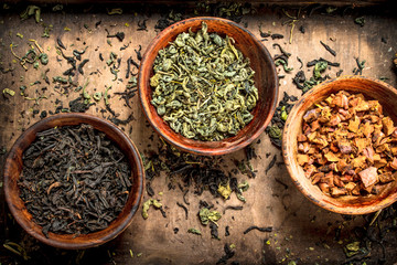 Different kinds of fragrant tea in bowls.