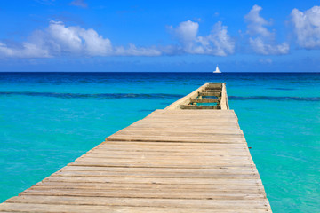 Perspective view of a wooden pier on the caribbean sea.