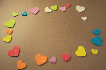 Flat lay design of colourful heart shape on wooden background for Love and valentine's day.