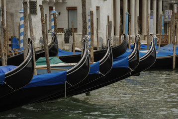 Fototapeta na wymiar Gondolas moored in a typical venetian canal - Venice, Italy