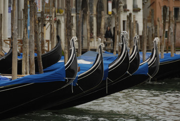 Gondolas moored in a typical venetian canal - Venice, Italy