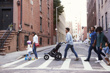 Two families with daughters crossing road