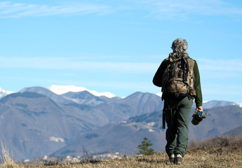 Trekker man walking alone though mountain 