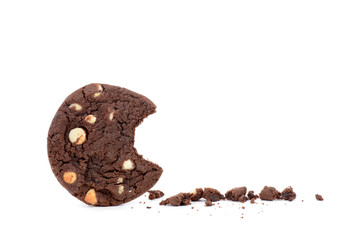 dark chocolate chip cookie with a bite and crumbs white background