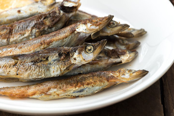 Grilled fish capelin or shishamo on white plate