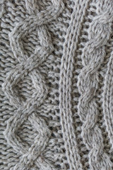 Closeup. Wool knitted fabric. Wool textiles. Colorful Wool scarv. Background. Large binding needles.