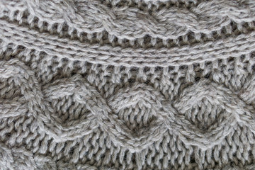 Closeup. Wool knitted fabric. Wool textiles. Colorful Wool scarv. Background. Large binding needles.