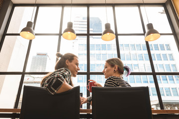 Two freelance working in coffee shop, Nomad worker conceptual, couple work together in cafe with laptop