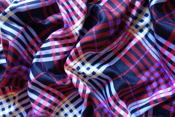 Folded multicolored fabric in shades of violet