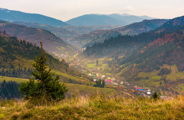 village in a beautiful valley in mountains. hazy autumnal landscape. location Mizhhirya,...