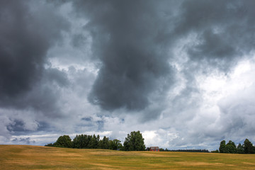 Obraz na płótnie Canvas Cloudy summer afternoon in latvian countryside.