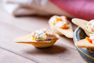 Tartlets with spicy salad on a wooden background 