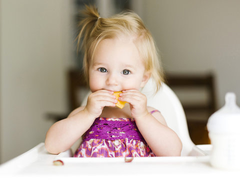 Portrait of cute baby girl eating food