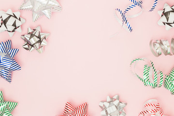 Festive copy space with wrapping pull bows on pink background. Holiday and sales flat lay concept,...