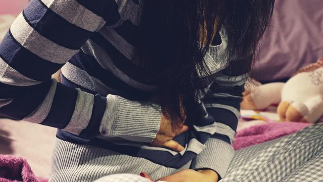 Closeup of hands on stomach feeling pain of woman