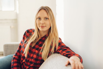 Fototapeta premium Serious young woman sitting staring thoughtfully
