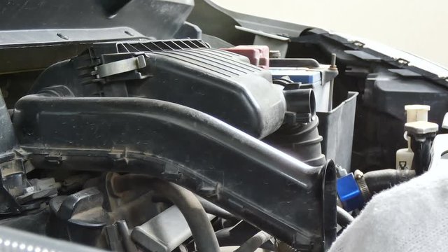 Close up shot mechanical using electric Blowers air force blowing to car engine for cleaning the dust with ambient sound