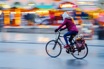 woman rides a bicycle in the city at night